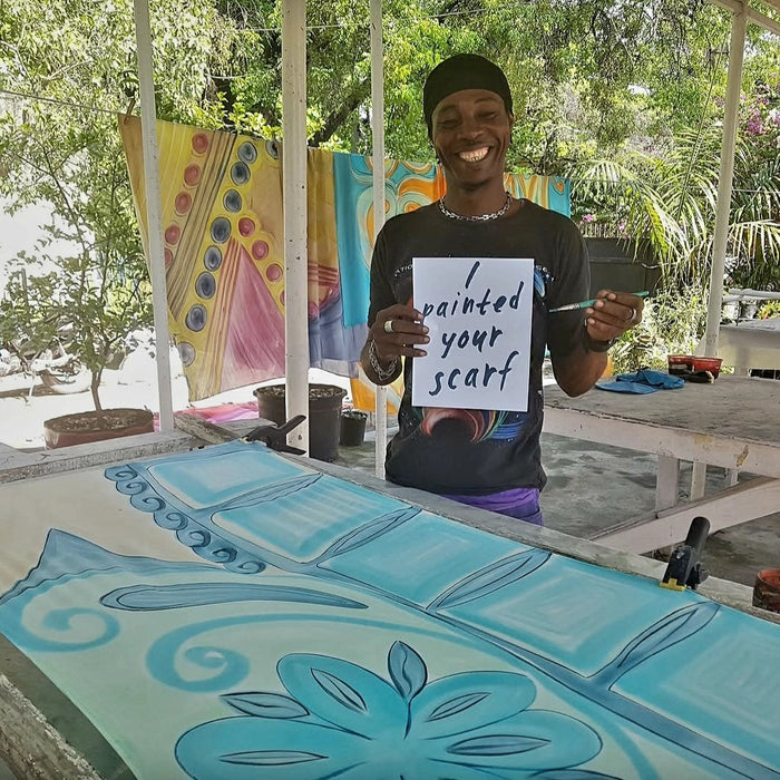 Artisan de Sandilou peignant un foulard à main levée dans l’atelierSandilou